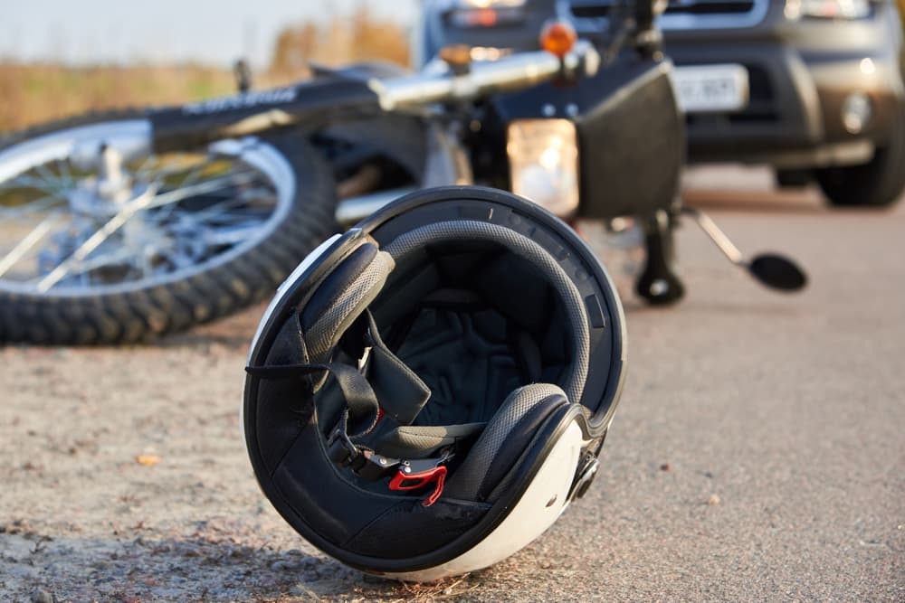 potential road accidents with a car, helmet, and motorcycle on the road, highlighting the risks associated with transportation.