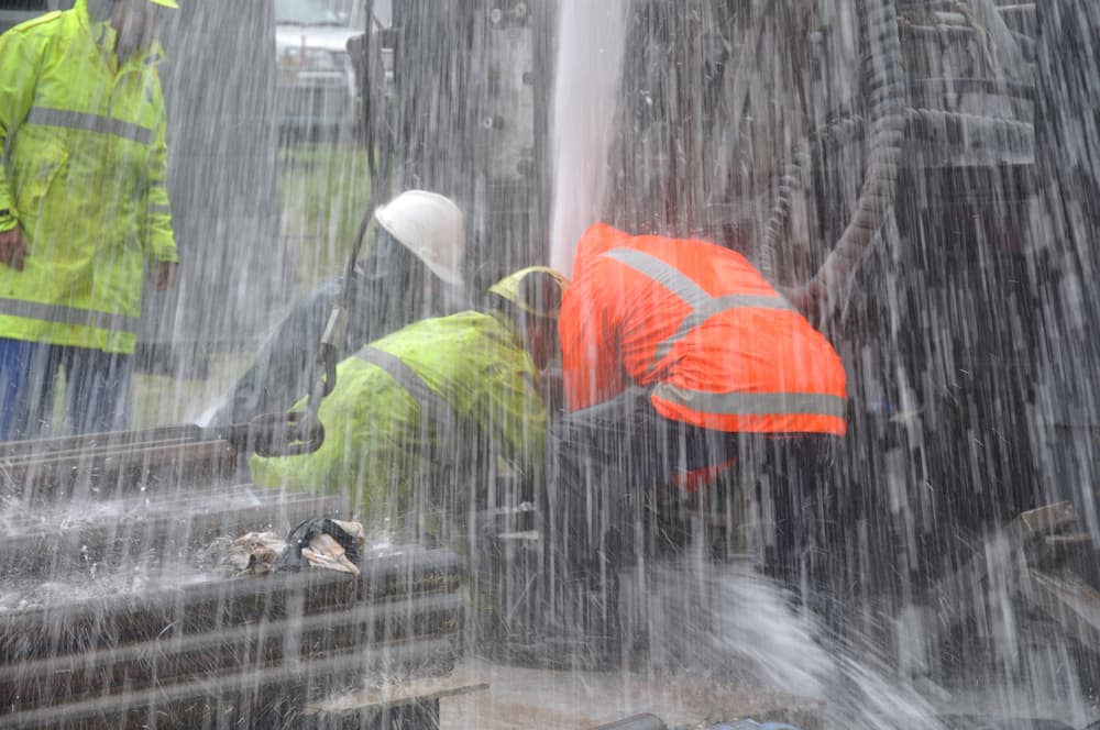 Drilling crewmen trying to control a small blowout