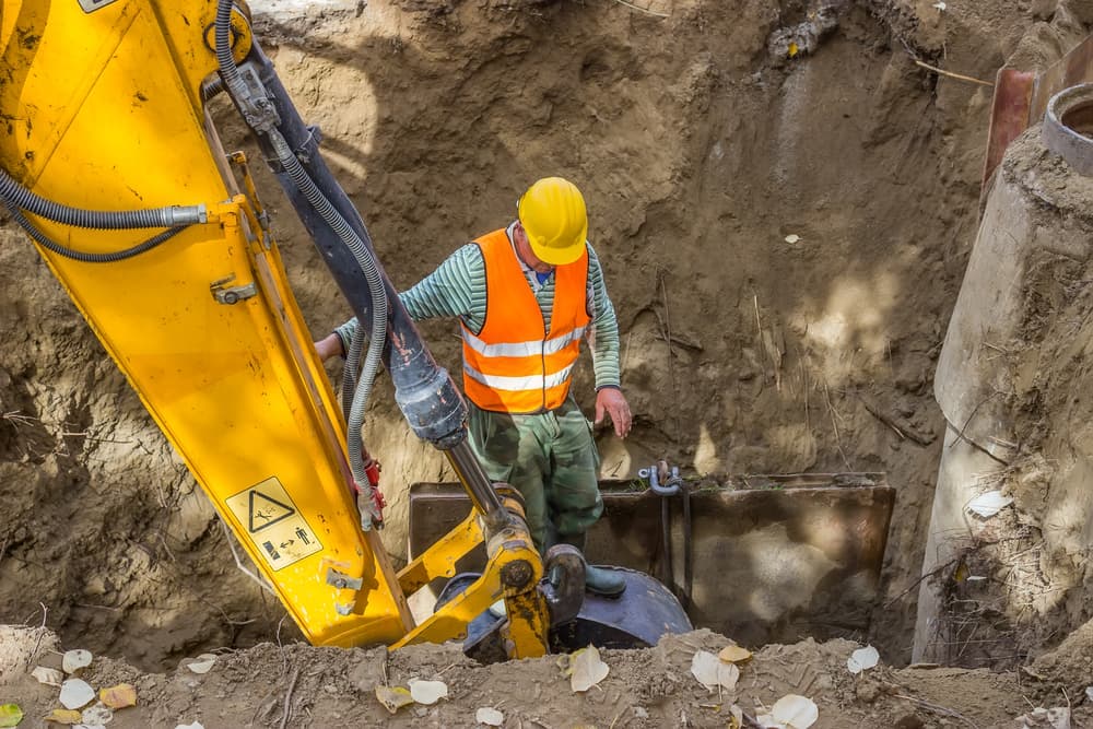 Construction worker working inside a trench